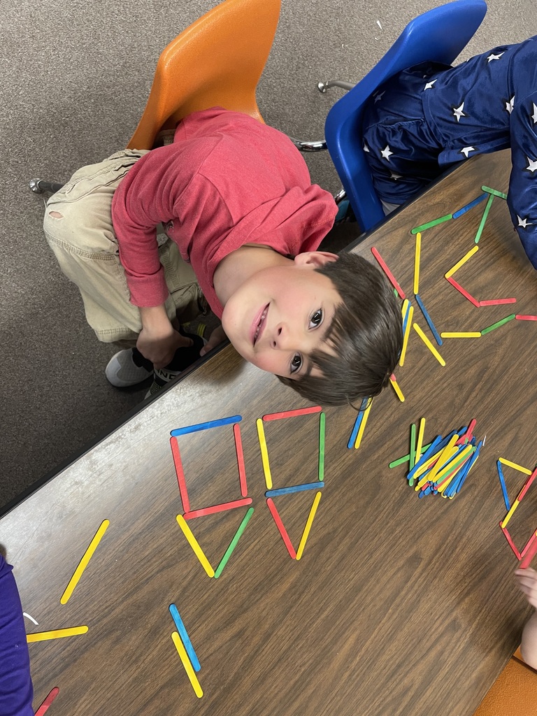 Wyatt making shapes out of popsicle sticks.